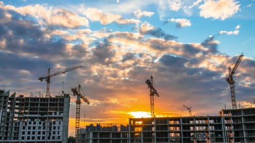 Cranes at Construction Site at Sunrise