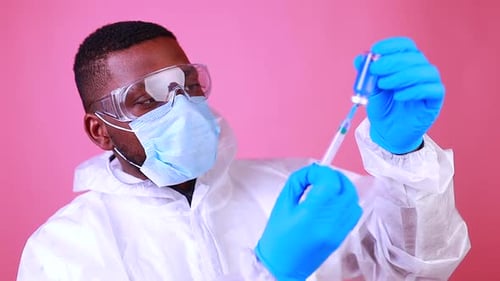Corona Virus SARSCoV2 Vaccination Concept Man in Pink Studio Wall Background