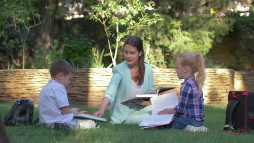 Teacher Instructing Children Outdoors in Sunny Park Setting