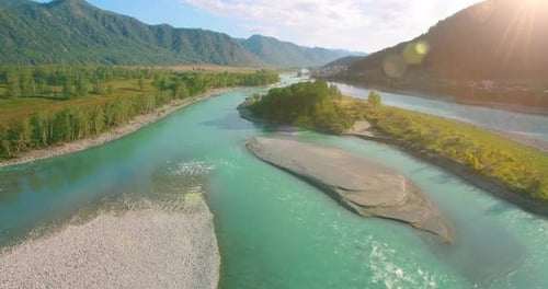 Low Altitude Flight Over Fresh Fast Mountain River with Rocks at Sunny Summer Morning.