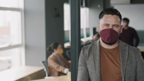 Man in Mask at Modern Workplace