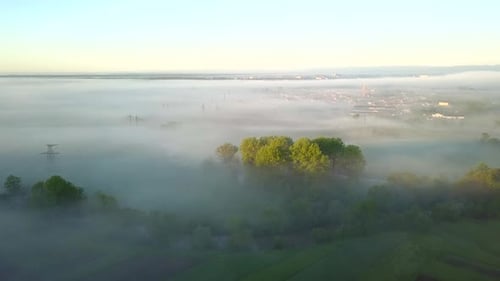 Aerial view of morning for over village houses on green spring hills.