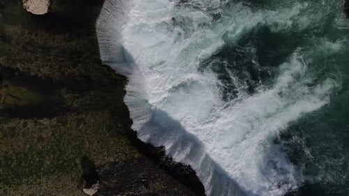 Slow Rising View of Waterfall Forming Bubbles