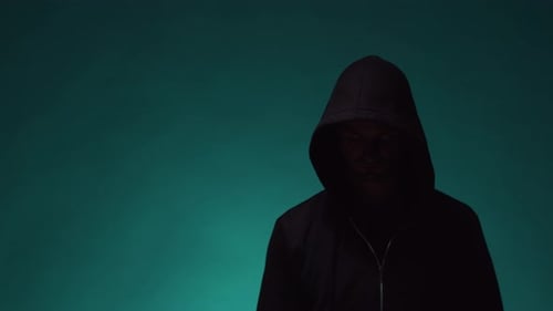 Man in Hoodie Touches Invisible Digital Screen