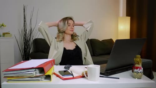 Young Adult Woman Working at Home on Laptop