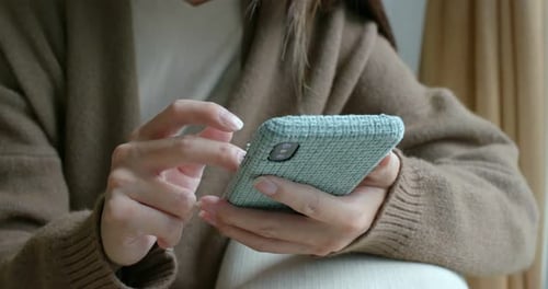 Frau berührt das Telefon zu Hause