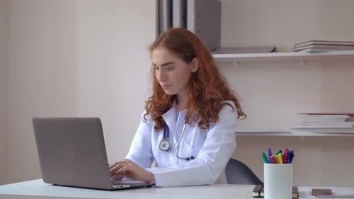 Therapist Using Pc in Clinic.
