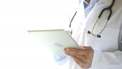 Medical Professional Uses Tablet for Healthcare