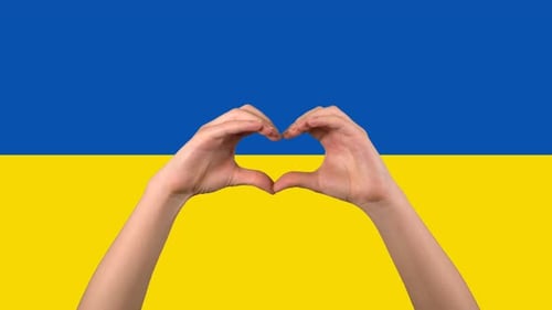 Hands Form Heart Shape Against Ukrainian Flag