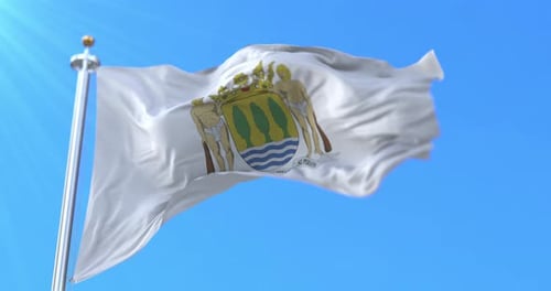 Waving White Flag with Coat of Arms on Clear Blue Sky