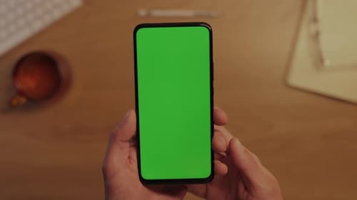 Man Tapping Green Empty Screen of Modern Smartphone
