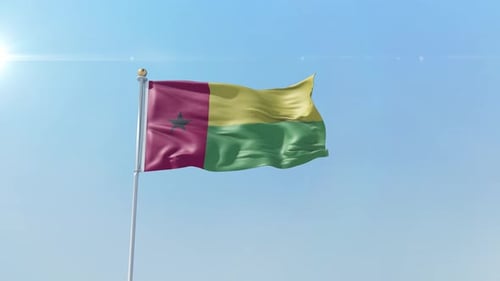 Realistic Guinea-Bissau Flag Waving in Wind Against Blue Sky