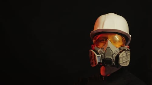 Man Wearing Respirator Mask, Safety Goggles and Hard Hat