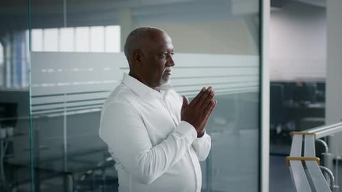 Confident Man Stands Proudly in Modern Office
