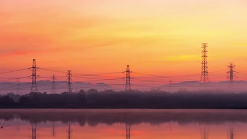 Still Lake Reflecting Sunrise with Power Lines