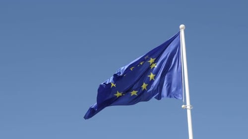 Rised on white flag-pole European Union flag waving on wind 4K 2160p 30fps UltraHD footage - Symbol