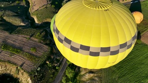 4K Aerial view of Goreme. Colorful hot air balloons fly over the valleys.