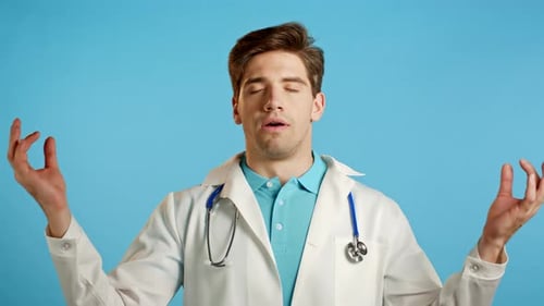 Calm Doctor in White Medical Coat Relaxing, Meditating. Man Calms Down, Breathes Deeply with Mudra