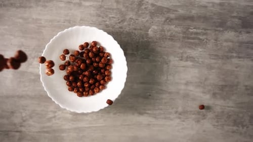 Chocolate Cereal Poured Into Bowl for Breakfast