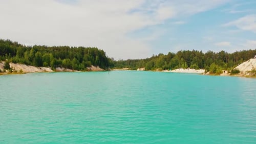 Landscape of a Light Blue Lake Surrounded By Forest