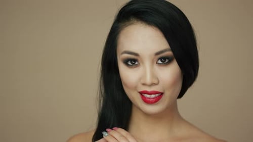 Young Woman with Bold Makeup Looking at Camera