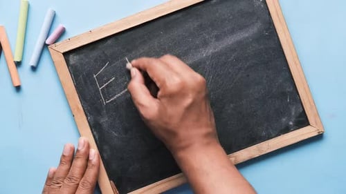 Hand Writes Error Message on Chalkboard