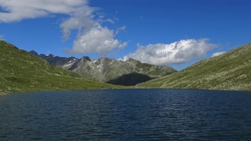 Scenic view on peak of mountains and lake in Swiss Alps