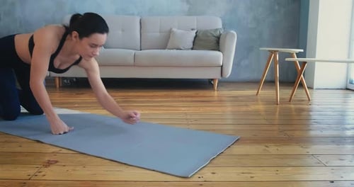 Woman Doing Plank Exercise on Yoga Mat Indoors