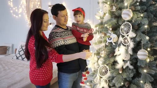 Family Decorates Christmas Tree in Cozy Home