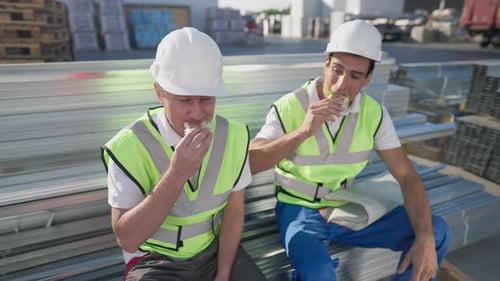 Construction Workers Enjoy Lunch Break Outdoors