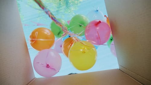 Child Opening Box With Colorful Balloons For Birthday