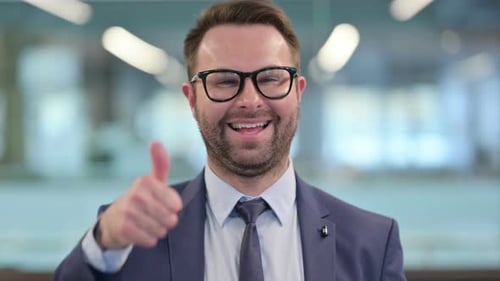 Cheerful Businessman Giving a Thumbs Up Gesture