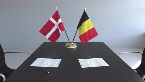 National Flags of Denmark and Belgium on Conference Table for Negotiations