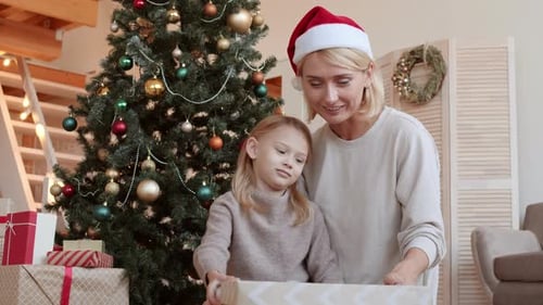 Mother and Child Opening Gift on Christmas Morning