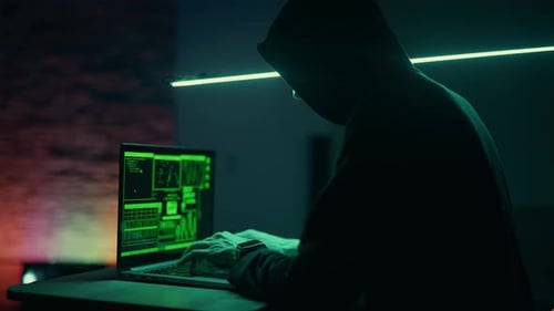Un hacker travaille sur un ordinateur portable la nuit