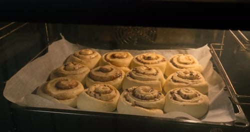 Cinnamon Rolls Baking Freshly Inside an Oven