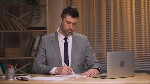 Focused Man Working at Desk in Office