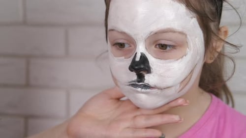 Child paint face for halloween.