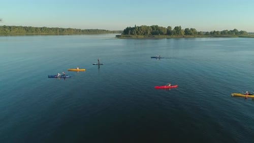 Aerial Drone Footage. Tourists Are Kayaking. Beautiful Sunrise Over River