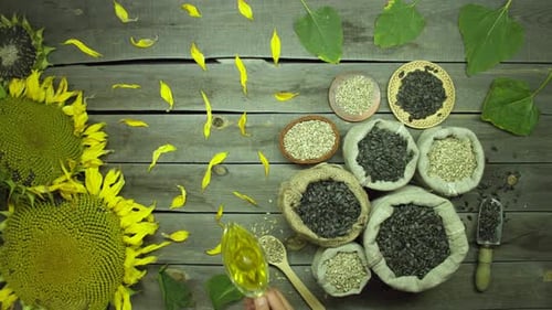Sunflower oil and seeds on an old wooden table. Top view.
