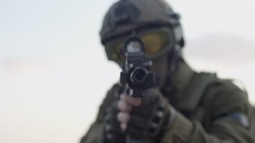 Person in Uniform Holding Weapon