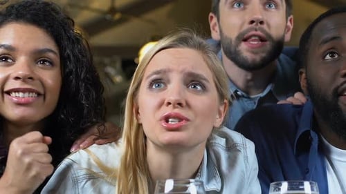 Group of Young Fans Attentively Watching Sport Game in Beer Pub, Championship