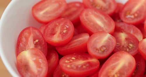 Fresh Red Halved Cherry Tomatoes in White Bowl