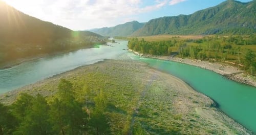 Low Altitude Flight Over Fresh Fast Mountain River with Rocks at Sunny Summer Morning.