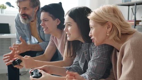 Excited Family Playing Video Games Together at Home