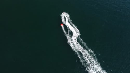 Jet Ski Pulling Inflatable on Sunny Ocean Day