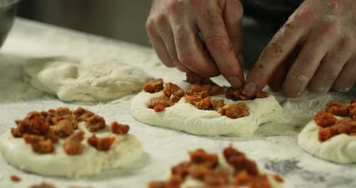 Hands Of A Baker Adding Pudding Into Dough - Closeup Shot