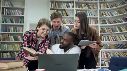 Multiracial Students which Doing Home Task in the University Library Using Computer