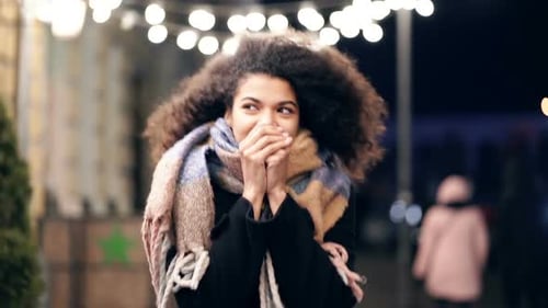 Happy woman walking at the evening street.