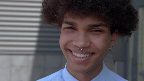 Close Up Of Smiling Young Man With Curly Hair